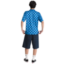 Person wearing a blue checkered shirt and dark shorts on a white background