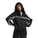 A woman modeling a black Vans zip-up jacket with a bold white and black checkered stripe pattern across the shoulders and sleeves, paired with matching black track pants against a solid white background.