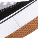 Close-up of a shoe sole with white, black, and brown colors on a white background