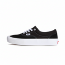 Black sneaker with white sole on a beige background