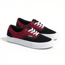 A pair of Vans platform sneakers in black and burgundy red canvas with white laces and thick white platform soles, photographed on a clean white background.