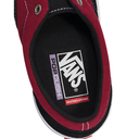Close-up of the inner side of a Vans Popcorn skateboarding shoe, showing a black canvas insole with the white Vans logo, a purple 'Popcorn' vertical label, and a red 'Skateboarding' tab, bordered by dark red and black canvas with white stitching.