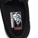 Close-up of a black Vans sneaker with a logo on the side.