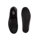 A pair of black slip-on loafers shown from the top and sole views on a plain white background. The top view shows a black leather upper with a textured woven pattern, a tassel detail, and a black Vans logo on the insole.