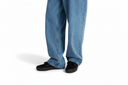 Blue jeans worn by a person on a white background