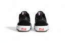 Black sneakers with white soles and red labels on a white background