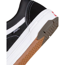 Close-up of a Vans sneaker with black, white, brown, and gray colors on a white background.