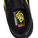 Close-up of the interior of a black Vans shoe with a bright yellow Vans logo patch, a purple PopCushion label, and a red Skateboarding label on the footbed.