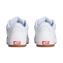 A pair of white Vans sneakers shown from the back, featuring white leather uppers, white midsoles, gum brown outsoles, and the signature red Vans 'Come Off The Shelf' logo on the heel.
