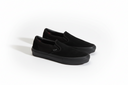Pair of black slip-on shoes on a white background