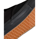 Close-up of a shoe sole with orange waffle pattern and black side panel on a white background