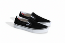 Black slip-on shoes with white soles on a white background
