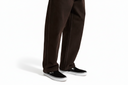 Brown pants worn by a person on a white background