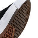 Close-up of a Vans Half Cab sneaker showing the brown gum outsole with its characteristic waffle pattern and white midsole.