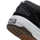 Close-up of a Vans Skate Half Cab shoe showing the heel and Wafflecap midsole, featuring a black upper, white Vans Off-The-Wall skateboarding patch, and a brown gum sole.