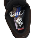 Close-up of the interior lining of a Vans shoe, showing the black Vans logo, a purple 'Pop Cushion' label, and a red 'Skateboarding' tab on a white background.