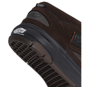 Close-up of a brown suede and mesh Vans sneaker showing the heel, outsole tread, and Vans branding on a white background.