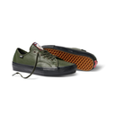 An olive green leather low-top sneaker with a black rubber sole and laces, shown alongside its black storage case on a white background.