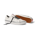 A pair of white low-top Vans sneakers with black laces, shown on a clean white background. One shoe is positioned upright, displaying its white leather upper, black laces, and white rubber sole.