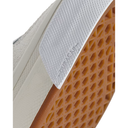 Close-up detail of a sneaker showing the white textured Dura-Cast midsole overlay and the orange-brown honeycomb-patterned rubber outsole.
