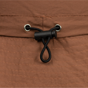 Close-up of a brown fabric with a black cord and metal loops.