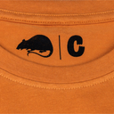 Close-up of an orange fabric with a black rat logo and 'C' lettering.