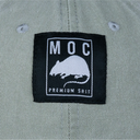 Label with 'MOC Premium Shit' text and logo on a green fabric background