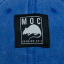 Blue denim shirt with a black patch featuring 'MOC' and a rat illustration.