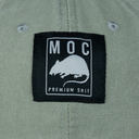Label with 'MOC Premium Shit' text and logo on a green fabric background