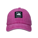 Pink cap with a black patch featuring a logo and text on a white background